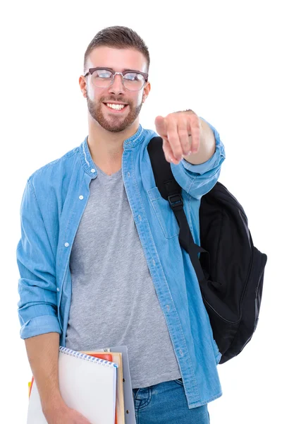 Чоловік студент зі шкільною сумкою тримає книжки і вказує на те, що ви ізольовані на білому тлі — стокове фото
