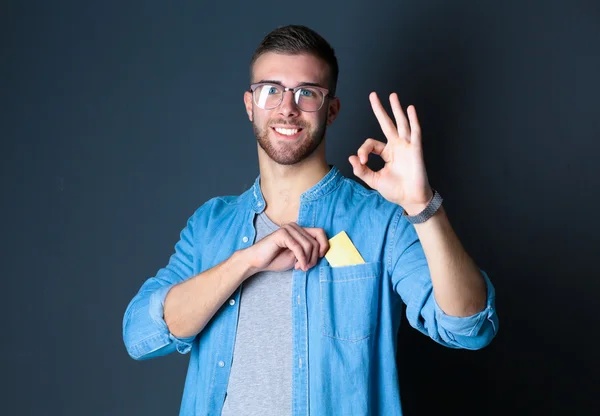 Man holding a credit card and showing ok — Stock Photo, Image