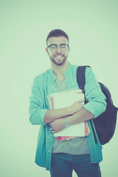Ein männlicher Schüler mit einer Schultasche mit Büchern auf weißem Hintergrund — Stockfoto