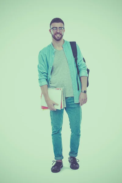 Beyaz arka plan üzerinde izole kitap tutan bir okul çantası olan bir erkek öğrenci — Stok fotoğraf