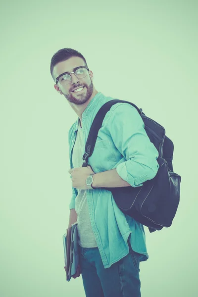 Uno studente maschio con una borsa della scuola che tiene libri isolati su sfondo bianco — Foto Stock