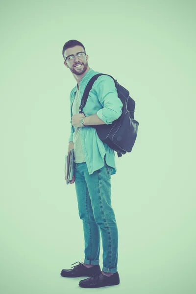 A male student with a school bag holding books isolated on white background — Stock Photo, Image