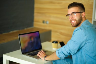 İnşaat üstünde belgili tanımlık laptop genç adam