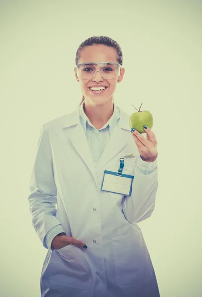 Smiling woman doctor with a green apple. — Stock Photo, Image