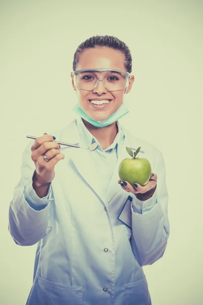 牙医医生女人拿在手里的绿色新鲜苹果和镜像 — 图库照片