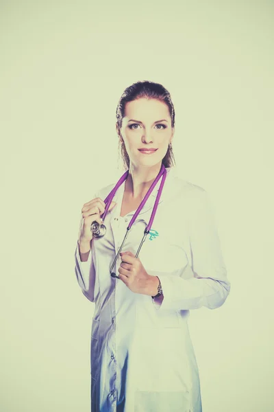 Smiling female doctor in uniform standing at hospital — Stock Photo, Image