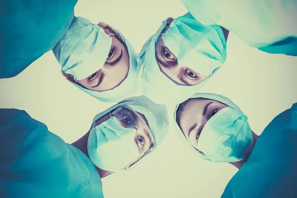 Surgeons team, wearing protective uniforms,caps and masks — Stock Photo, Image