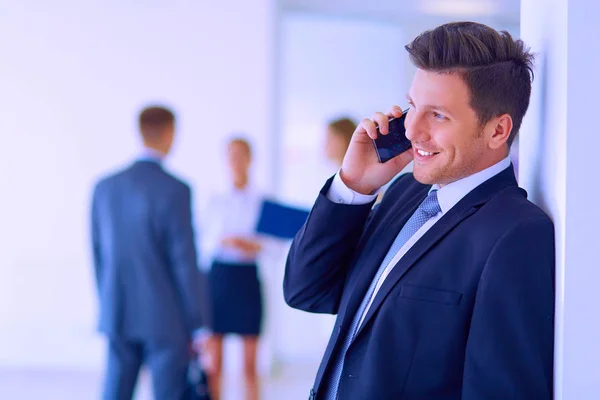 Business man using his mobile phone in office — Stock Photo, Image