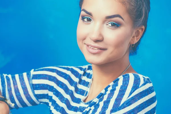 Happy beautiful young woman doing wall painting, standing near ladder — Stock Photo, Image