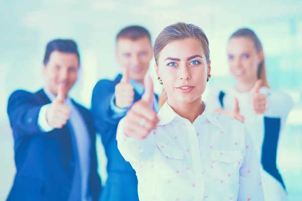 Happy business team showing thumbs up in office — Stock Photo, Image