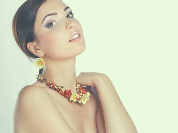 Portrait of young beautiful brunette woman in beads — Stock Photo, Image