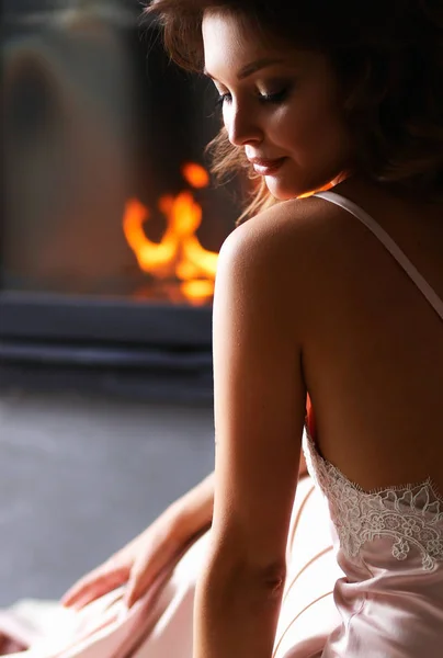 Sexy girl in front of the fireplace — Stock Photo, Image