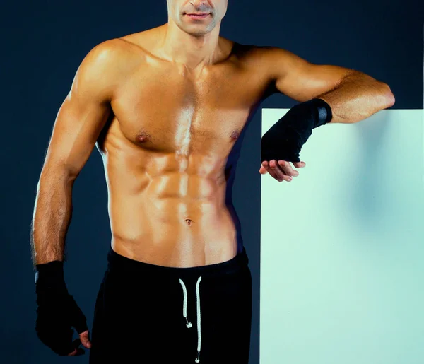 Muscular man holding blank — Stock Photo, Image