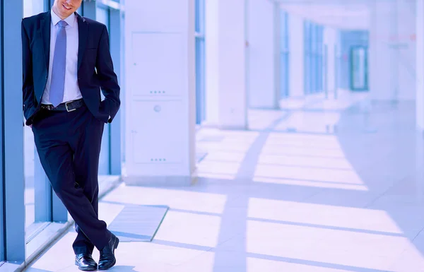 Successful businessman standing in hallway his company near window — Stock Photo, Image