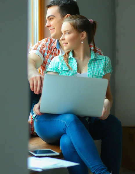 Fiatal házaspár új otthon ülő laptop portréja — Stock Fotó
