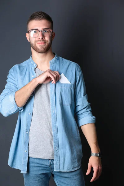 Man holding a credit card , isolated on black background — Stock Photo, Image