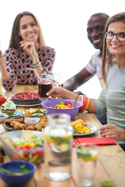 People with drinks while sitting at the dining table — Stock Photo, Image