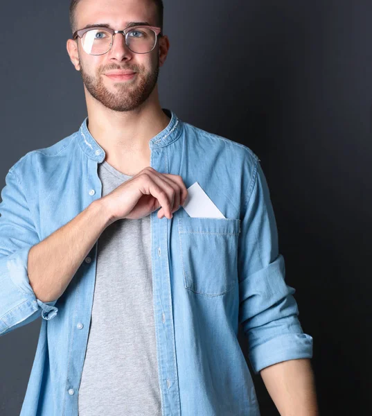 Man holding a credit card , isolated on black background — Stock Photo, Image