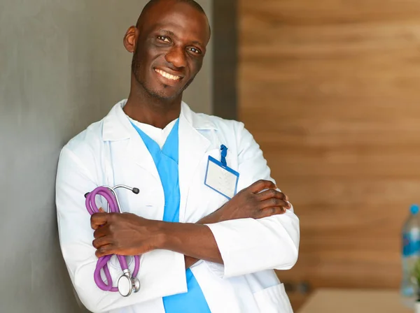 Doctor with arms folded in modern office