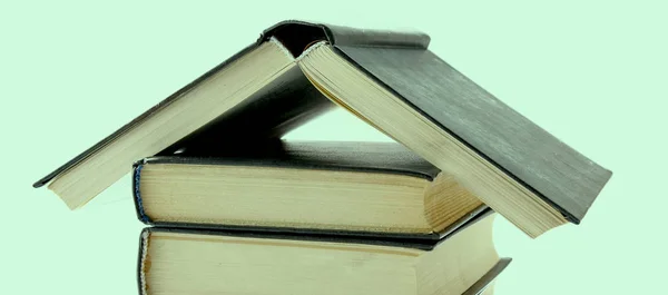 Casa fatta con libri accatastati su sfondo bianco — Foto Stock