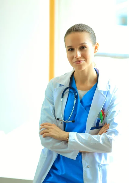 Woman doctor standing at hospital near window — Stock Photo, Image