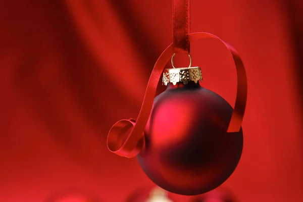 Christmas red balls on a bowl, on red background — Stock Photo, Image