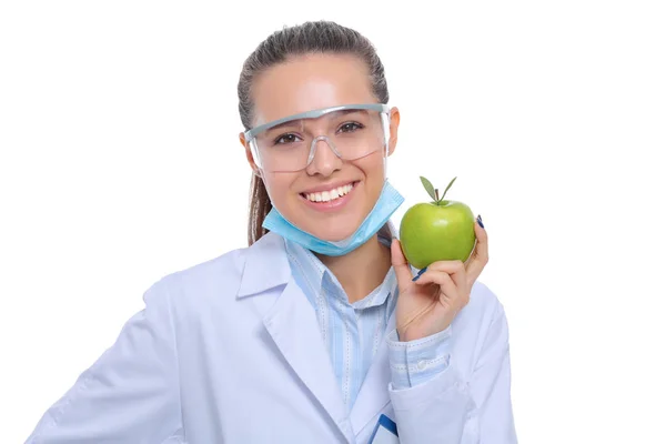 Mosolygó nő orvos egy zöld alma — Stock Fotó