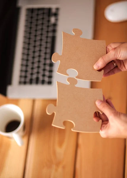 Business woman holding and pointing to a puzzle piece — Stock Photo, Image