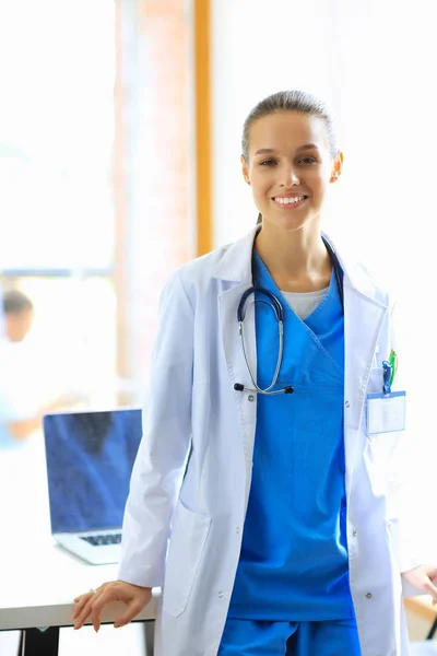 Kvinna läkare står vid sjukhus nära skrivbord — Stockfoto