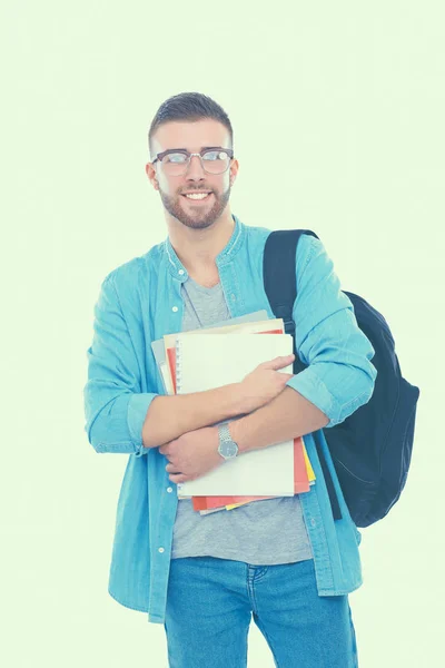 Studente maschio con una borsa della scuola che tiene libri isolati su sfondo bianco — Foto Stock