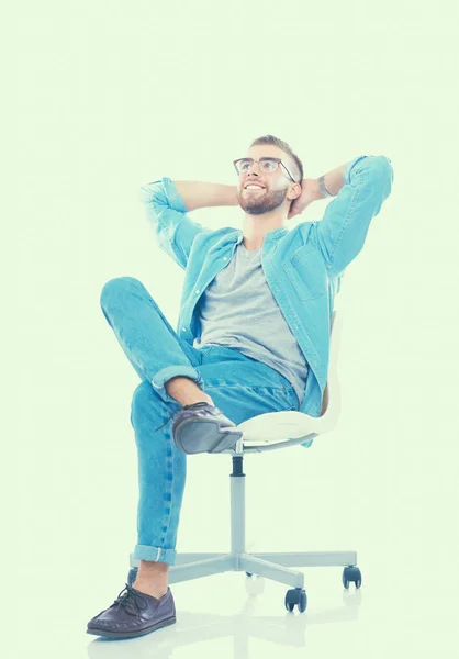 Young man sitting on the chair isolated over white background — Stock Photo, Image