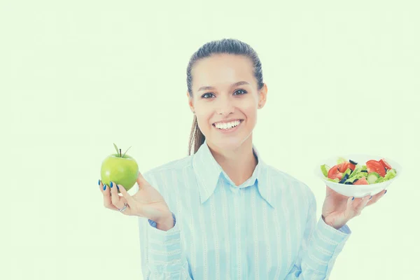 Portrait of a beautiful woman doctor holding plate with fresh vegetables and green apple — Stock Photo, Image