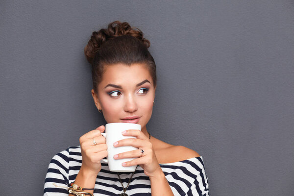 Portrait of young woman with cup tea or coffee