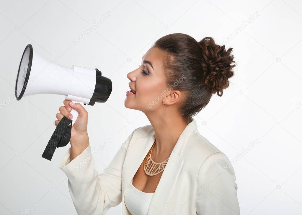 Business woman with megaphone yelling and screaming isolated on white background