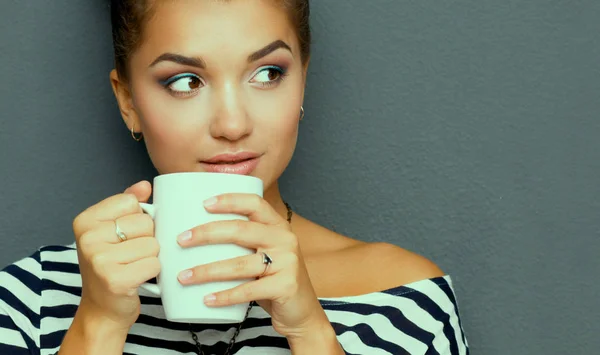 Portrait of young woman with cup tea or coffee — Stock Photo, Image