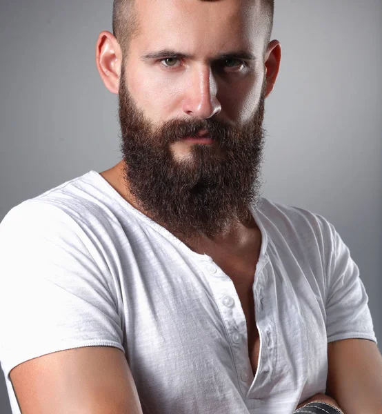 ハンサムなひげを生やした男立っている、灰色の背景上で分離の肖像 — ストック写真