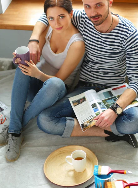 Casal em movimento em casa sentado no chão — Fotografia de Stock