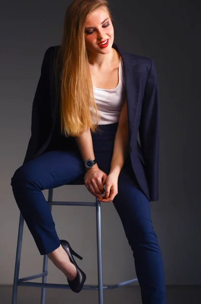 Young woman sitting on a chair — Stock Photo, Image