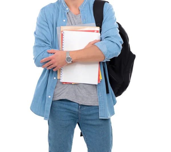 Jovem estudante do sexo masculino com saco escolar segurando livros isolados em fundo branco — Fotografia de Stock