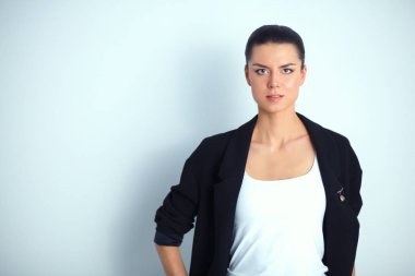 ayakta, gri arka plan üzerinde izole genç kadın