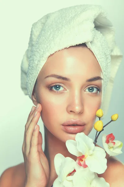 Portrait of beautiful girl touching face with a towel on her head — Stock Photo, Image