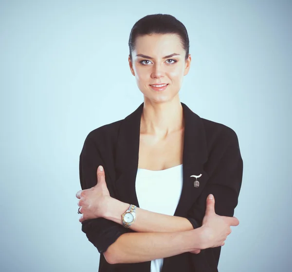 Young woman standing, isolated on gray background — Stock Photo, Image