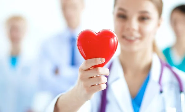 Female doctor with stethoscope holding heart — Stock Photo, Image