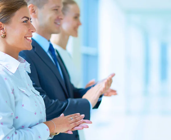 Smiling business people applauding a good presentation in the office Stock Image