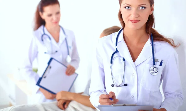 Woman doctor with folder standing at hospital — Stock Photo, Image