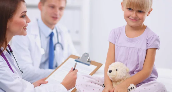 Female doctor examining child with stethoscope at surgery — Stock Photo, Image