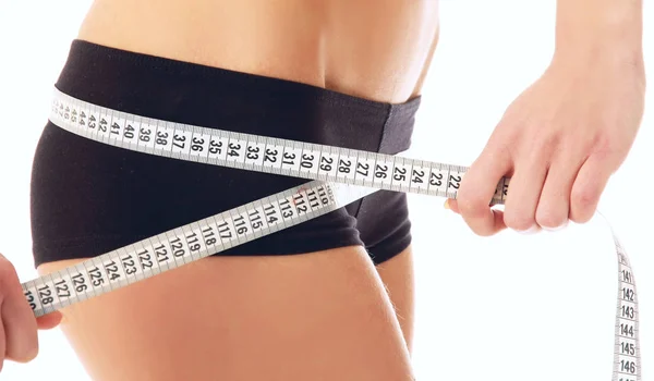 Woman measure her waist belly by metre-stick — Stock Photo, Image