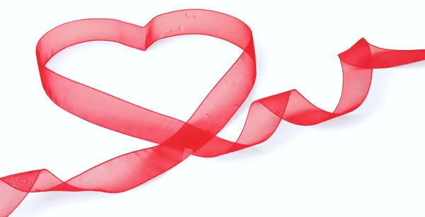 A red ribbon shaping heart , isolated on white background — Stock Photo, Image