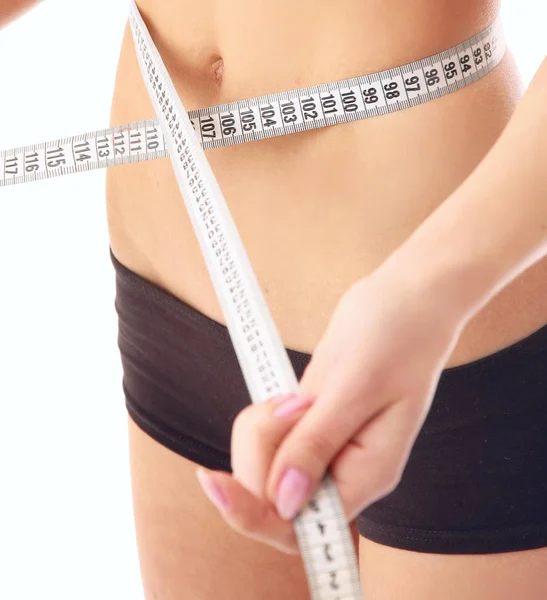 Woman measure her waist belly by metre-stick Royalty Free Stock Photos
