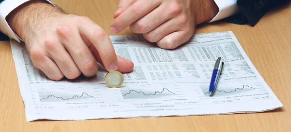 Geschäftsmann sitzt auf dem Schreibtisch und hält Geld in der Hand — Stockfoto